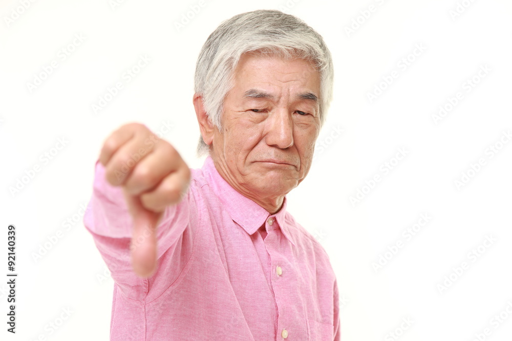 senior Japanese man with thumbs down gesture senior Japanese man with thumbs down gesture