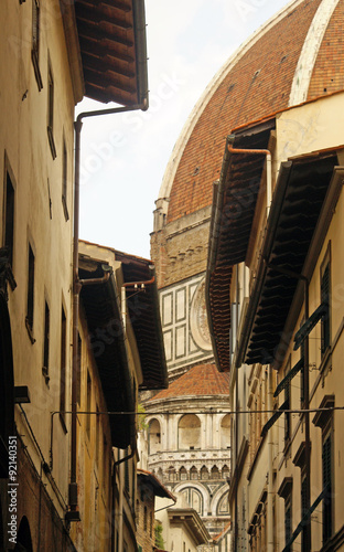 The narrow street in Florence, with views of the Cathedral of Santa Maria del Fiore photo