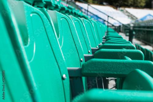 green plastic seat on stadium © theerapakorn