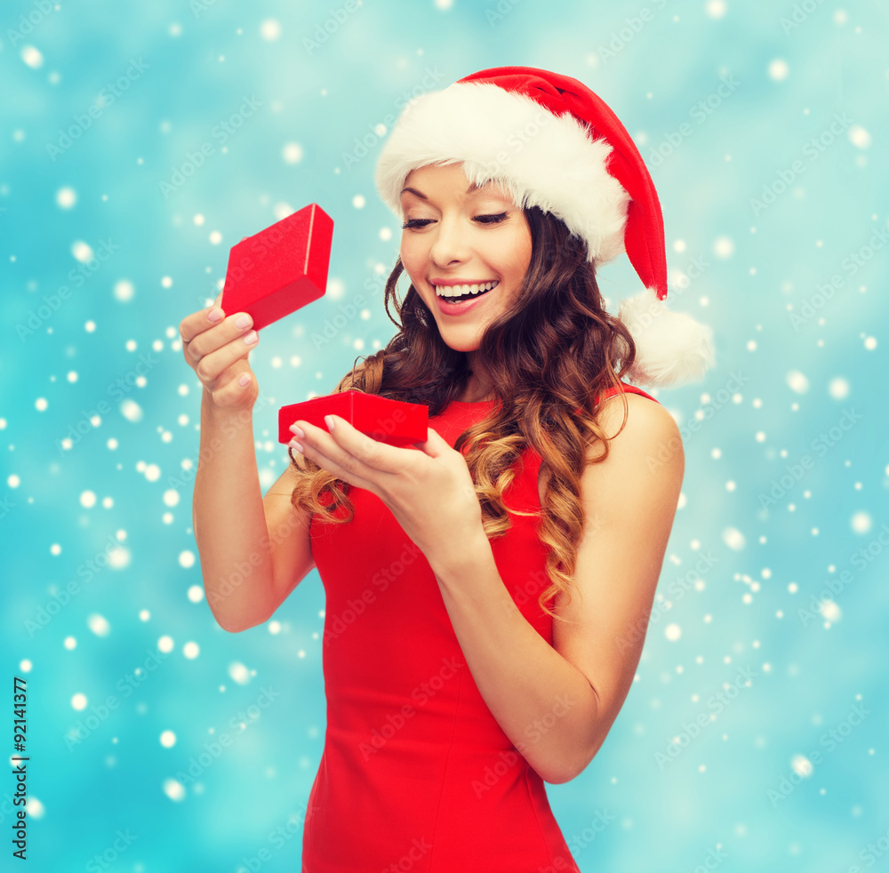 smiling woman in santa helper hat with gift box