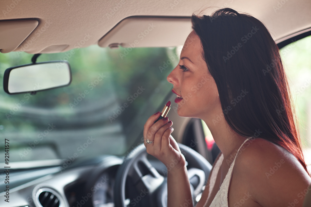 beautiful woman doing makeup in the car beautiful woman doing makeup in the car