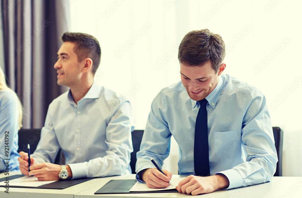 group of smiling businesspeople meeting in office group of smiling businesspeople meeting in office