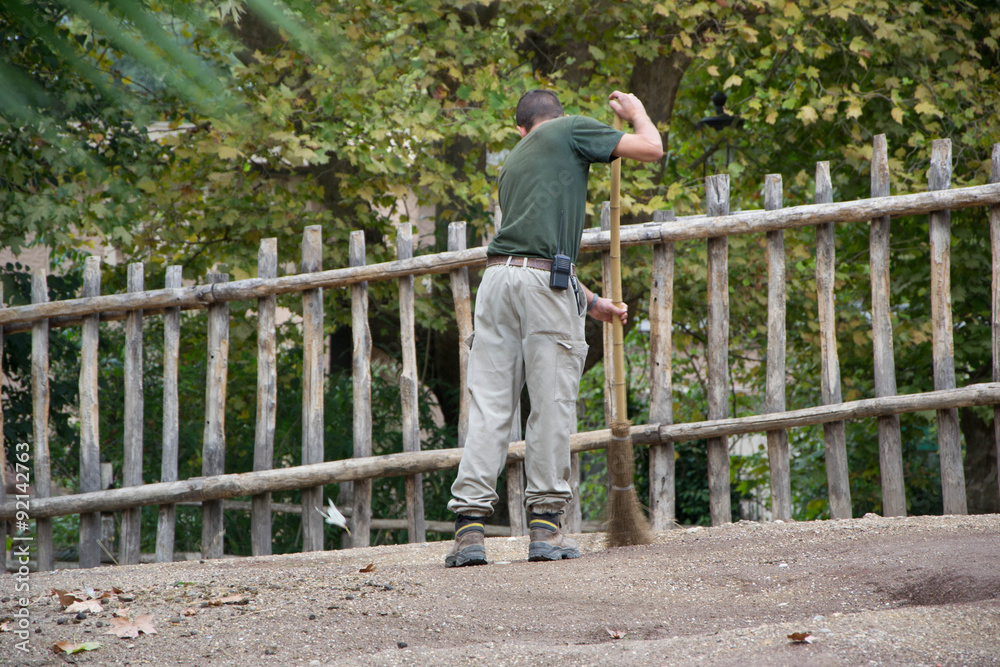 937 - man cleaning the cages at the zoo 937 - man cleaning the cages at the zoo