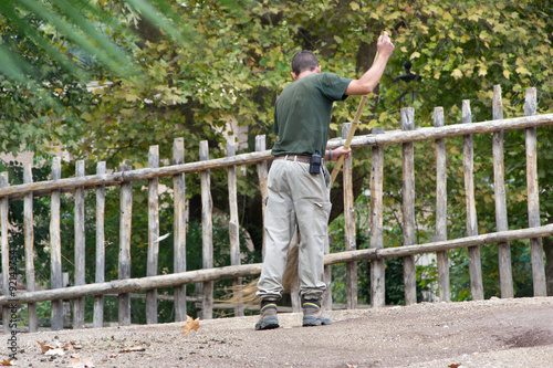 936 - man cleaning the cages at the zoo