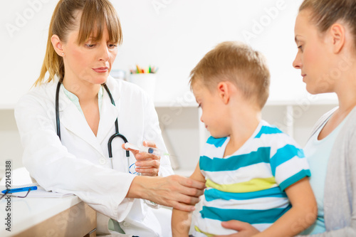 Little boy at the doctors appointment getting vaccinated
