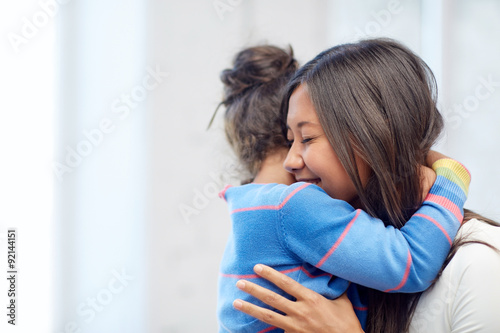 Fotografie, Tablou happy mother and daughter hugging at home