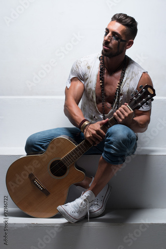 Man with Acoustic Guitar Sitting on Steps