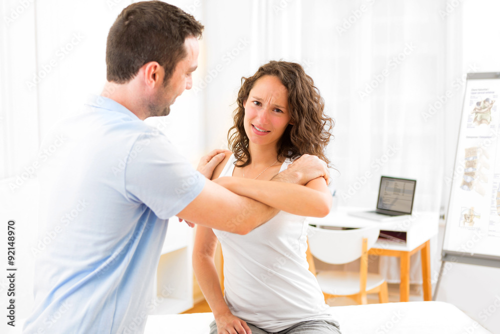 Young attractive woman being manipulated by physiotherapist Young attractive woman being manipulated by physiotherapist