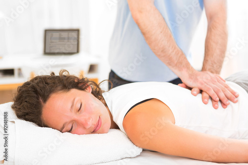 Young attarctive woman being manipulated by physiotherapist