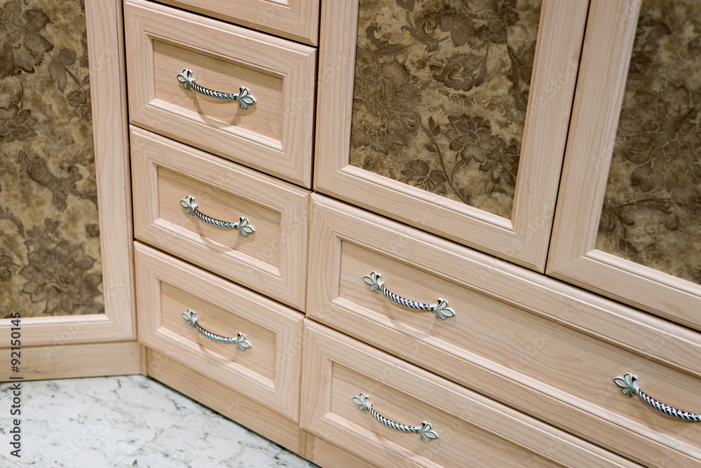 Fragment of beige cupboard with drawers