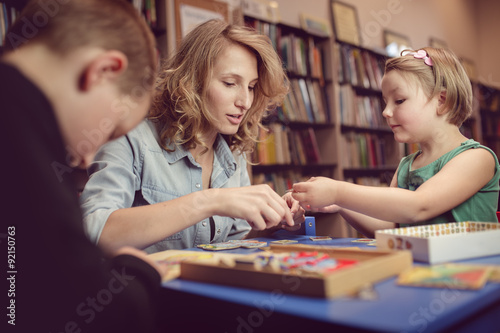 Education and fun. Kids with teacher playing games in classroom