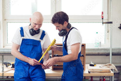 two worker in a carpenter's workshop