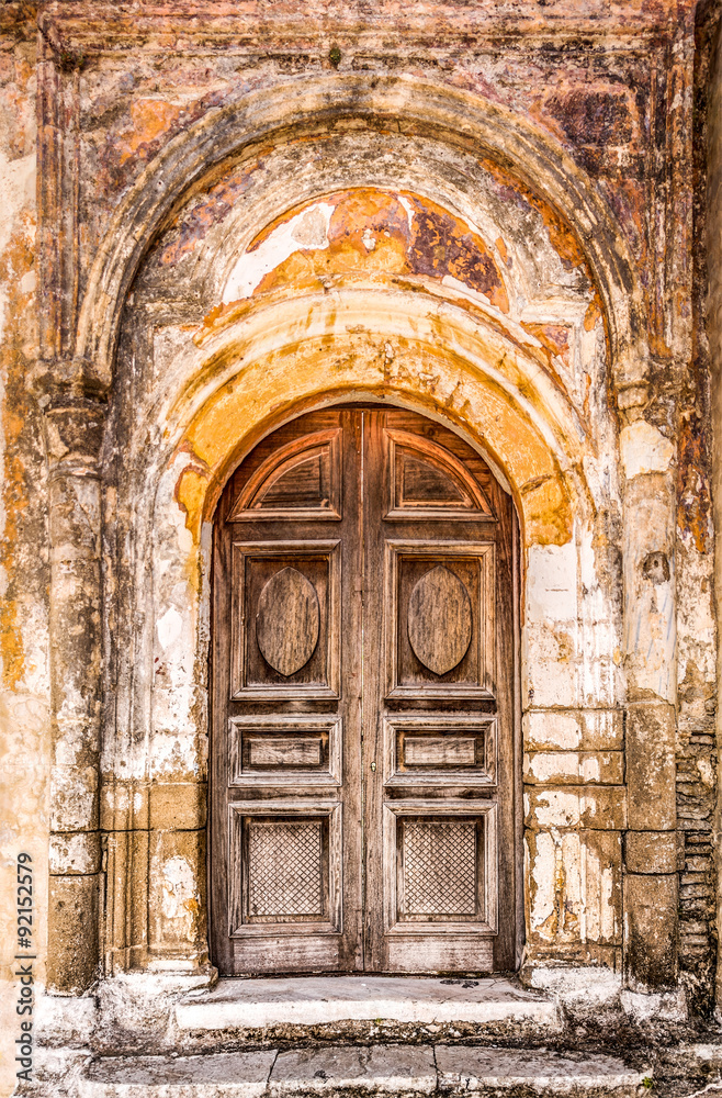 Old closed door with highly textured doorway