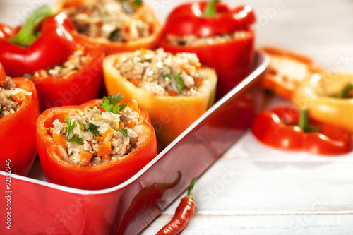 Stuffed bell peppers on white wooden table