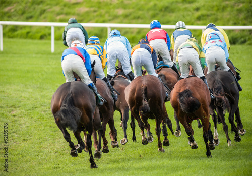 racehorses and jockeys racing down the track