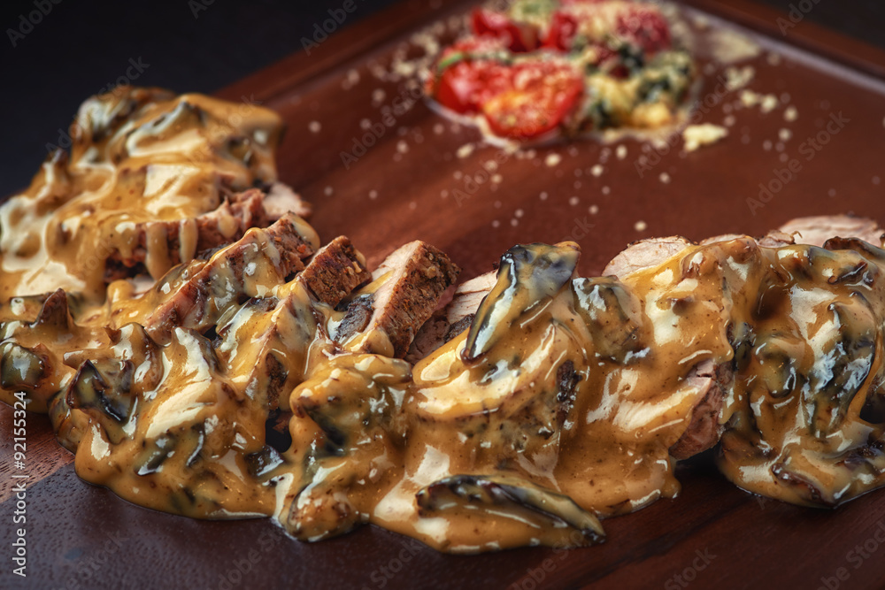 grilled beef with tomato in cream sauce on the board grilled beef with tomato in cream sauce on the board