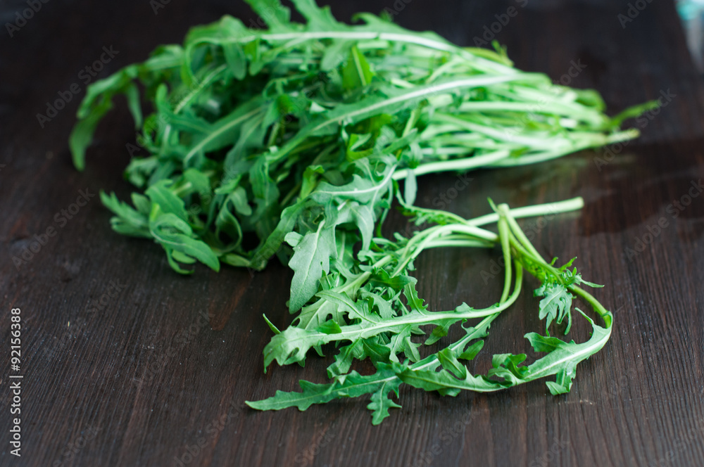 fresh ruccola leaves on the wooden background fresh ruccola leaves on the wooden background