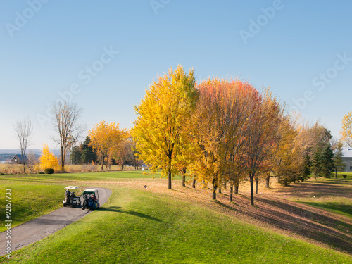 Golf in fall with carts to the fairway
