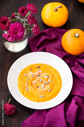 Pumpkin cream-soup with seeds in a plate