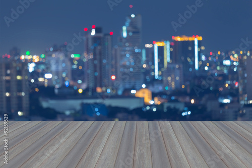 Canvas Print Opening wooden floor, City of Bangkok blur bokeh lights during twilight with wat