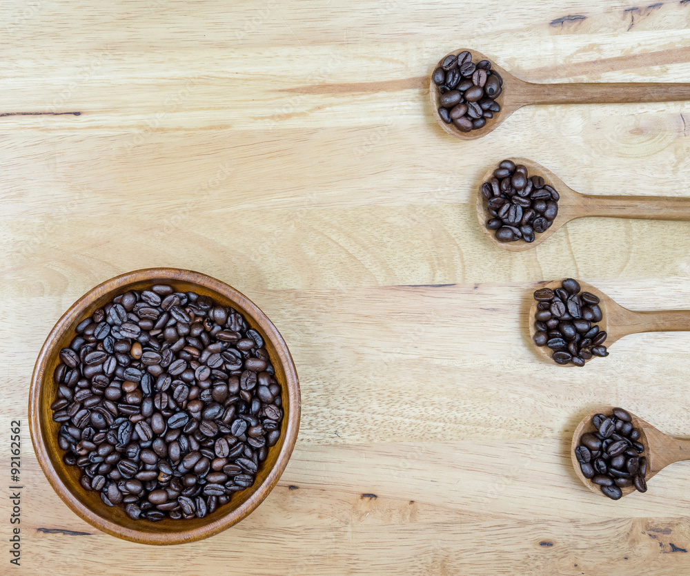 coffee beans and wooden spoon on the table background coffee beans and wooden spoon on the table background