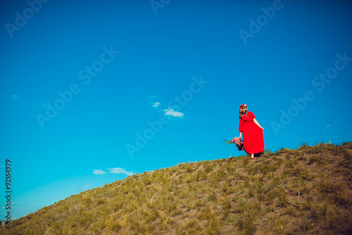 Girl in the Red Dress is Walking on the Field