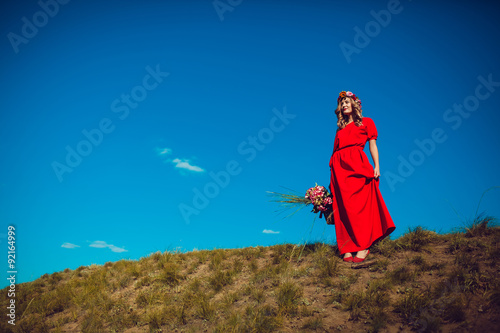Girl in the Red Dress is Walking on the Field