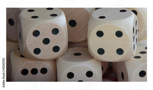 A Stack of Traditional Wooden Six Sided Gaming Dice.