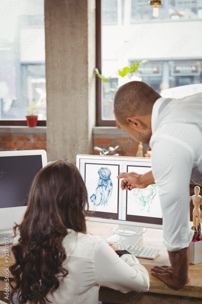 Man showing design to woman Man showing design to woman