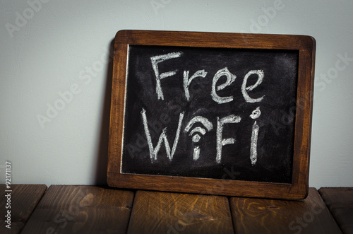 Free wifi sign. Wooden table.