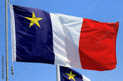 Fényképezés Acadian Flag with Blue Sky Background, Newfoundland, Canada