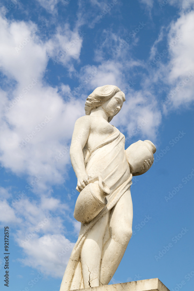 Statue showing a greek mythical muse at blue sky