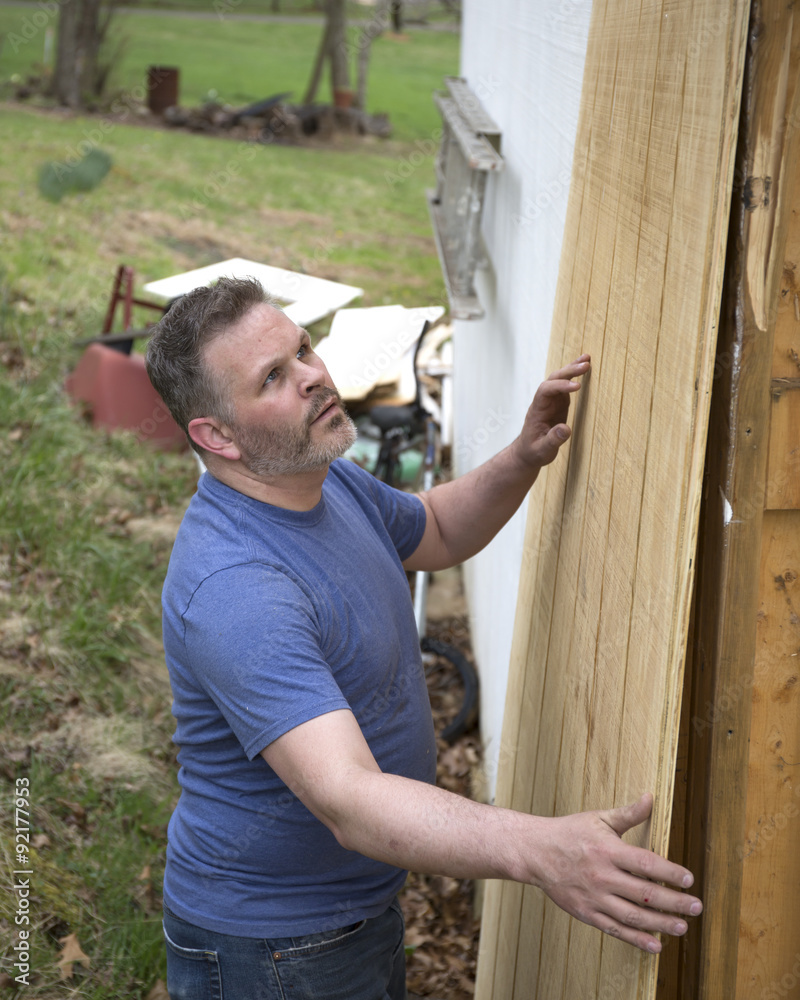 Carpenter working with a wooden board Carpenter working with a wooden board