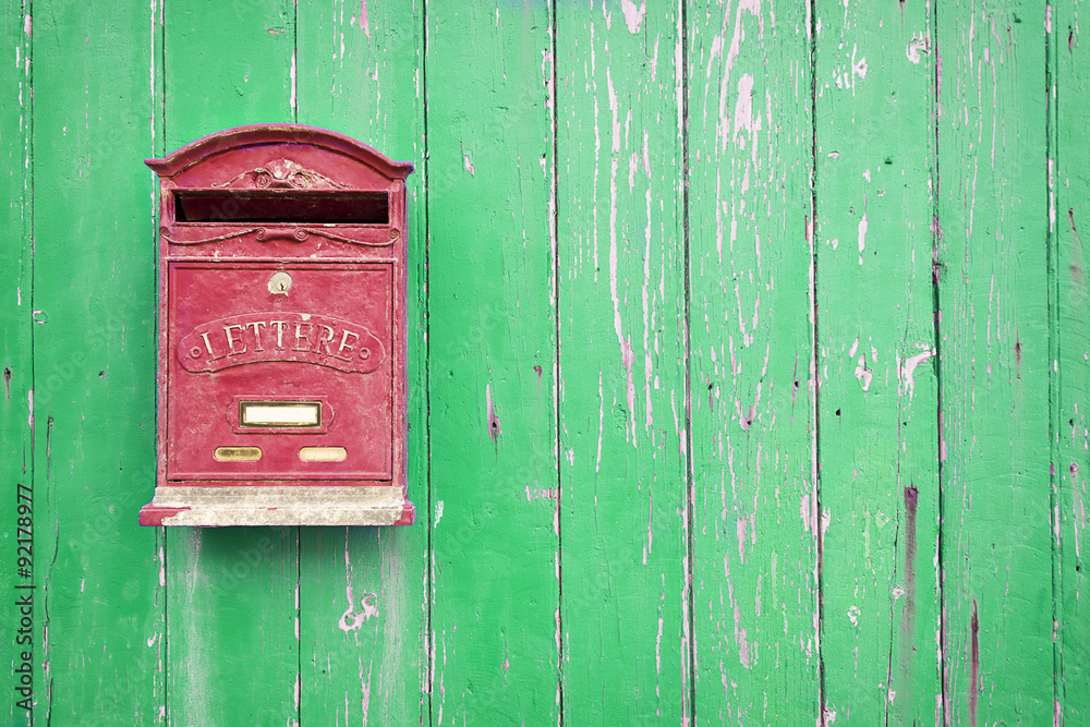 Red mailbox with green wood background Red mailbox with green wood background