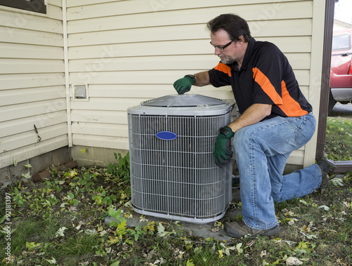 Repirman Tightening Fan Shroud On Outside Air Conditiong Unit