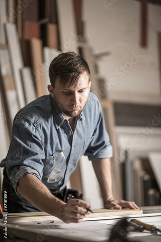 Carpenter at work in workshop © Photographee.eu