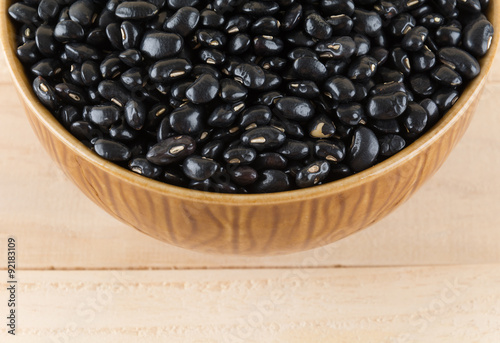 black beans on wood background