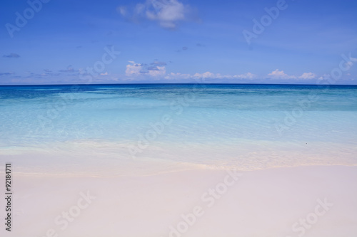 blue sky with sea and beach - soft focus with film filter