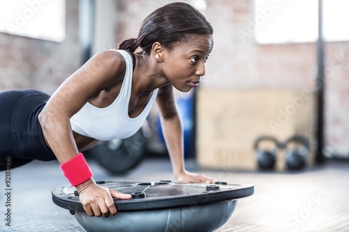 Young woman exercising in gym photo