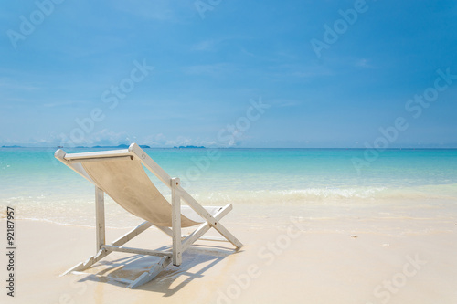 beach chair on beach with blue sky