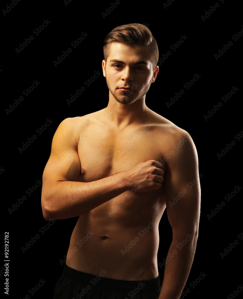 Fototapeta premium Muscle young man on dark background