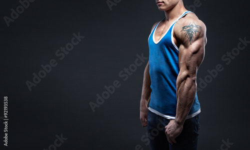 strong man in jeans shows triceps photo