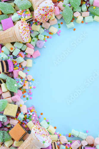 Bright colorful candy on pale blue wood table.