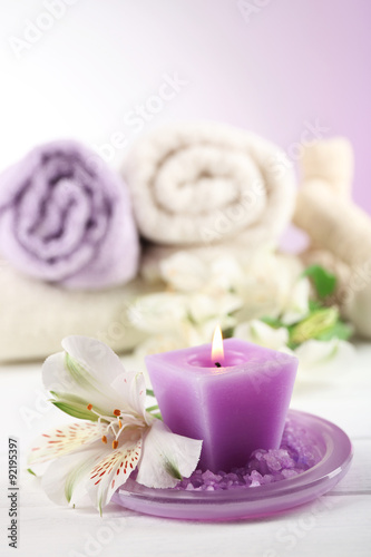 Spa treatment and flowers on wooden table  on light background