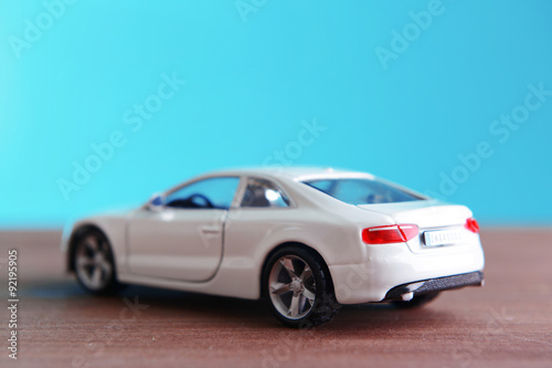 Small toy car on blue background © Africa Studio