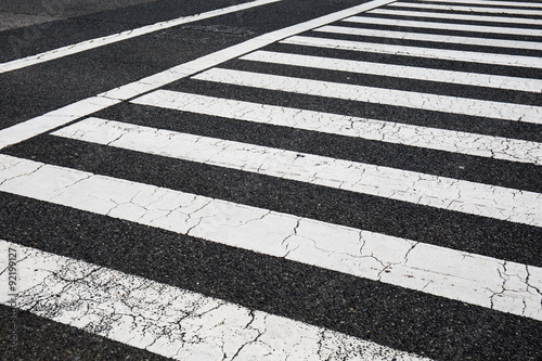 Pedestrian crossing, zebra traffic walk way on asphalt road © aradaphotography