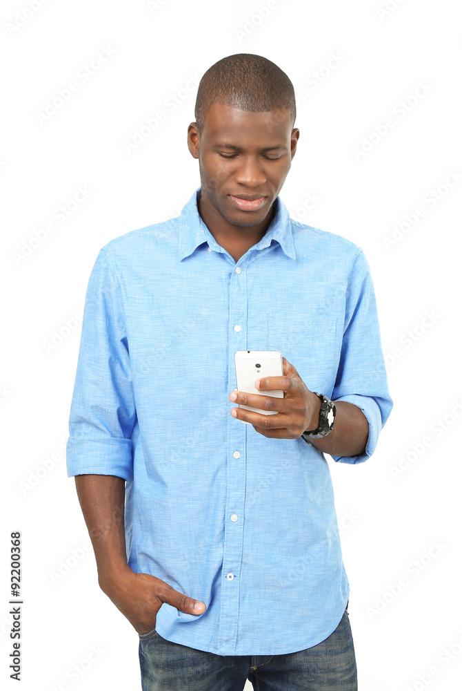 Handsome African American man holding mobile phone isolated on white Handsome African American man holding mobile phone isolated on white