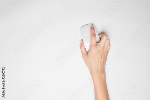A female(woman) hand hold a mouse isolated white at the studio.