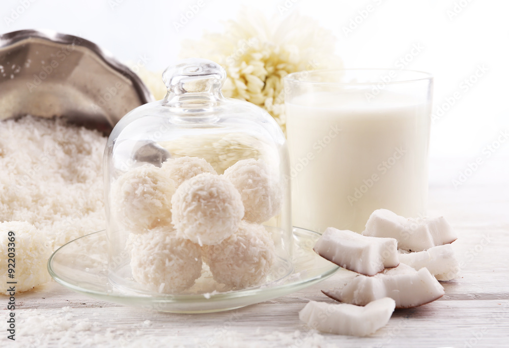Homemade Candies in coconut flakes and fresh coconut on light background Homemade Candies in coconut flakes and fresh coconut on light background