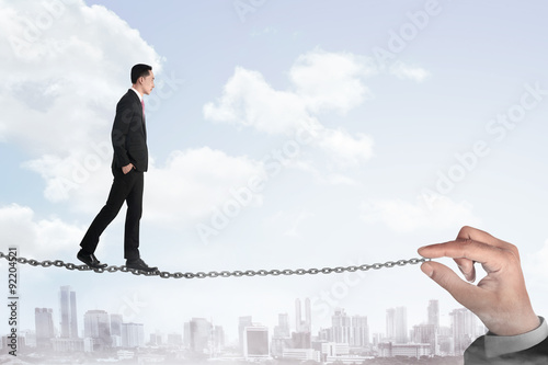 Business person walking on the chain